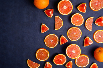 Fresh red orange or grapefruit cut juicy slice on a blue classic background. Tropical citrus fruit....