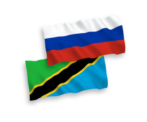 National vector fabric wave flags of Tanzania and Russia isolated on white background. 1 to 2 proportion.