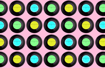 pattern of multicolored vinyl discs on a pink background