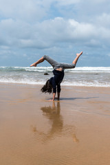 Child doing handstands at the beach at Phillip Island, Victoria Australia