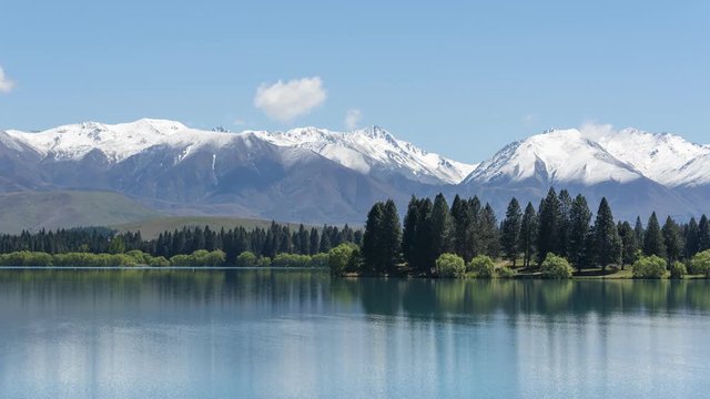 Time lapse of a calm Lake Ruataniwha on a sunny day, with the snow-capped Southern Alps in the background. Mackenzie Basin, Canterbury District, New Zealand.