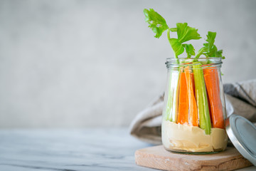Zero waste snack - hummus with carrot and cilantro, rustic background, copy space
