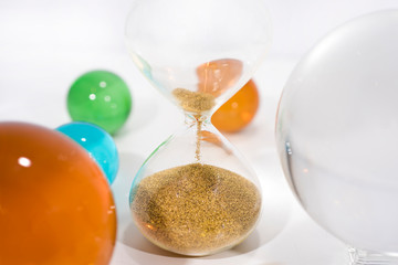Time abstraction. Glass balls with sand clock reflections.