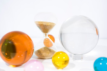 Time abstraction. Glass balls with sand clock reflections.