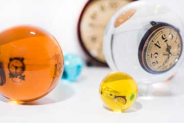 Time abstraction. Glass balls with sand clock reflections.