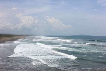 beach, sea, and clouds on batu hiu, west java, indonesia
