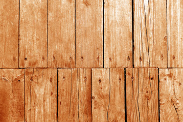 Old grungy wooden planks background in orange tone.