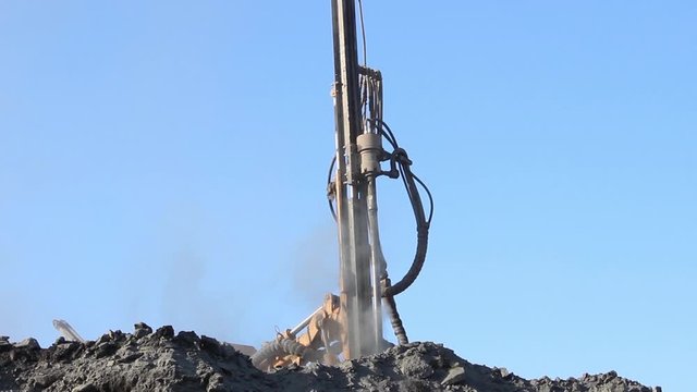 The drilling rig does its job in an open pit. Drill is drilling.