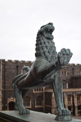 Close up focus of bronze lion statues at the entrance of Norwich City Hall, Norfolk, England, UK. Norwich Guildhall out of focus in background.