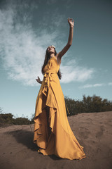 Fototapeta premium Attractive girl in the yellow dress