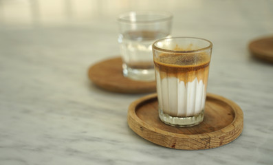 Close up ice coffee  latte in transparent glass on timber table
