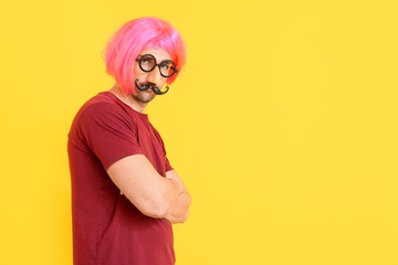 Man in funny disguise on color background. April fools' day celebration