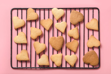 Patern of homemade heart shaped cookies on pink. Flat lay.