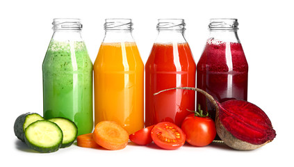 Bottles of fresh vegetable juices on white background