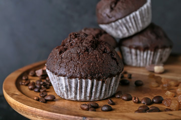 Tasty chocolate muffins on stand, closeup