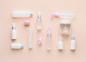 Different cosmetic products on color background