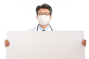 An Asian doctor holding a blank message board.