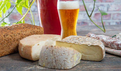 cheeses and Tomme de Savoie with beer, French cheese Savoy, french Alps France.