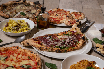 Traditional Neapolitan dishes. Calzone, Iberian, pizzas, pasta dish.Isolated image. Mediterranean cuisine.