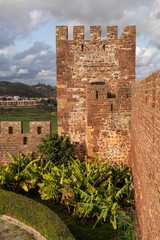 Fototapeta premium Golden hour view of Silves Castle ruins and watchtower in the winter sunshine