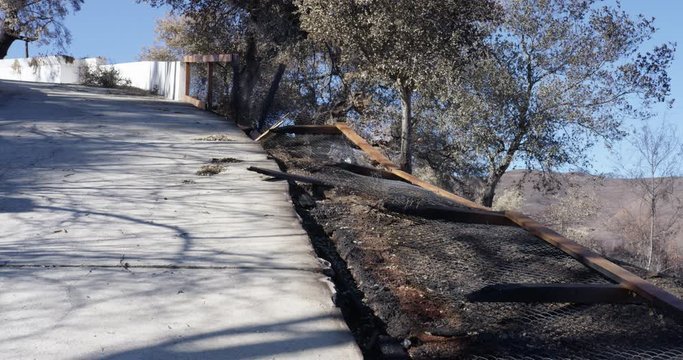 Burned fence along driveway in Malibu, California. Woolsey Fire.