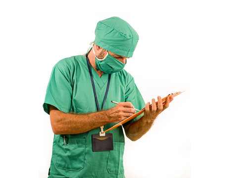 Isolated Portrait Of Attractive And Handsome Medicine Doctor Or Hospital Nurse Man In Surgical Bouffant Hat And Medical Scrub Holding Clipboard Working Paperwork