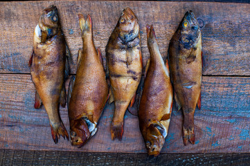 Medium-sized fish perch caught in a small river far from the city and plants, clogged with cherry...