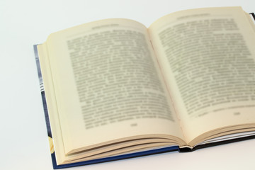 Open book with blurred text on white background