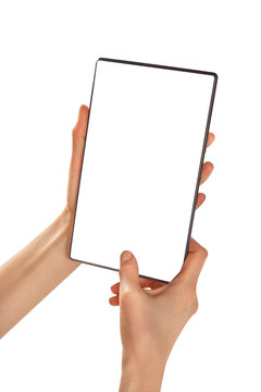 Female hands hold a blank tablet vertically. An empty tablet in female hands is on a white background.