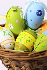 Fototapeta na wymiar easter eggs in basket on wooden background