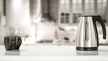 Kettle on white desk and kitchen interior 