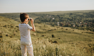 Boy with binoculars exploring nature