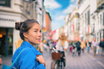 Tourist chinese young woman walking in city street shopping on travel vacation in fall autumn...