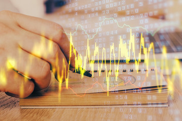 Multi exposure closeup hands with stock market forex graph.