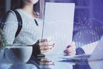 Double exposure of hands making notes with forex chart huds. Stock market concept.