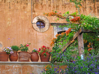 Fototapeta na wymiar Old monastery wall and pots in Crete
