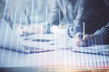 Multi exposure of forex chart with man working on computer on background. Concept of market...