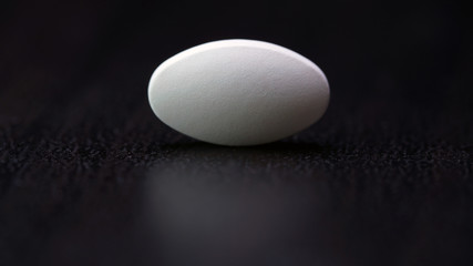 the white tablet is isolated on a black background.