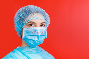 Portrait of a woman wearing medical uniform and mask with virus text at red background. Coronavirus concept. Protect your health concept with copy space