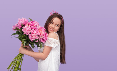 Smiling girl with pink crown and peonies