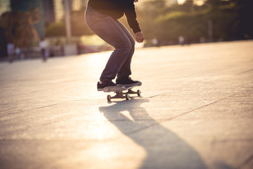 Skateboarder skateboarding at sunset city