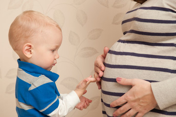 Pregnant woman with her son. Belly of a pregnant woman