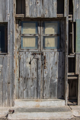 Fototapeta na wymiar front view of old wooden door with window of a warehouse or a barn, vintage old warehouse wooden gate, wooden texture or background