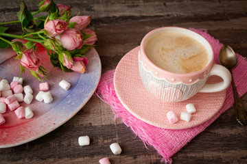 Hot chocolate or coffee in cup wit heart and knitted effect with marshmallow and roses