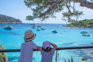 landscape, sea coast, children look at the perfect blue sea water Mallorca Spain