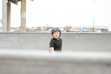 Young boy wearing skate helmet playing at the skate park in Portland, Victoria Australia