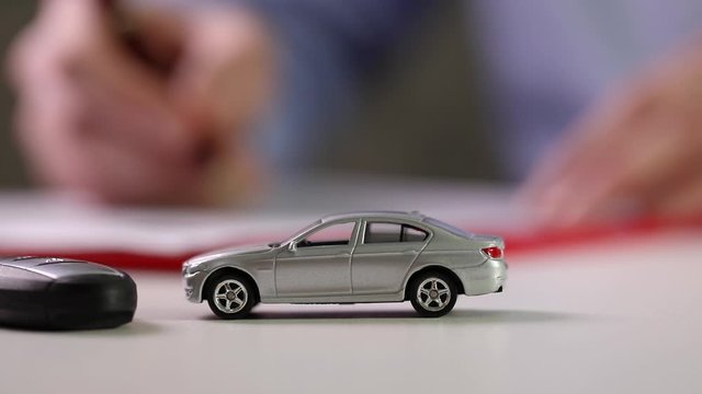 buy new car concept - signing contract in office