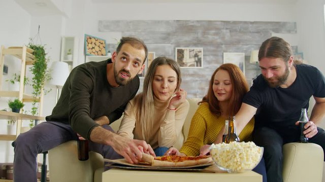 Group of friend enjoying a tasty pizza while socializing