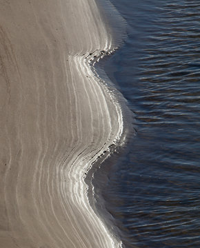 Surat Bay Owaka beach. Catlins New Zealand. Sand and water. Shoreline.