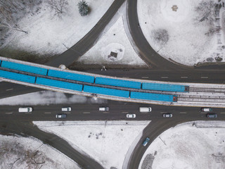 Aerial drone view. Trains of the Kiev metro passing on a snowy bridge.